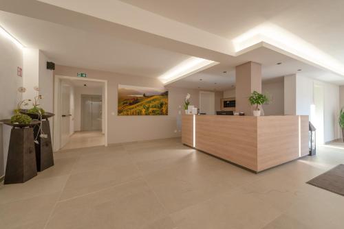 a lobby with a reception desk in a building at Vineus Tramin in Termeno