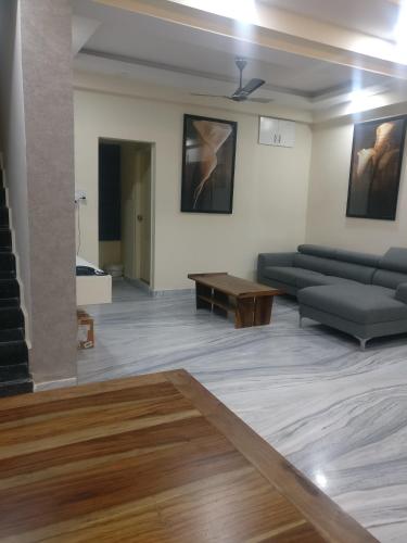 a living room with a couch and a table at Misty Lake Guest House in Hyderabad