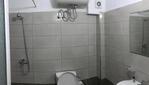 a bathroom with a shower and a toilet at Hotel Tatzati in Sarandë
