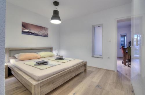a bedroom with a large bed in a room at BC Eleven - mit Zentralheizung in Senj