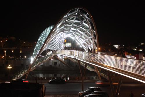 a bridge with lights on it at night at Nika7 in Tbilisi City