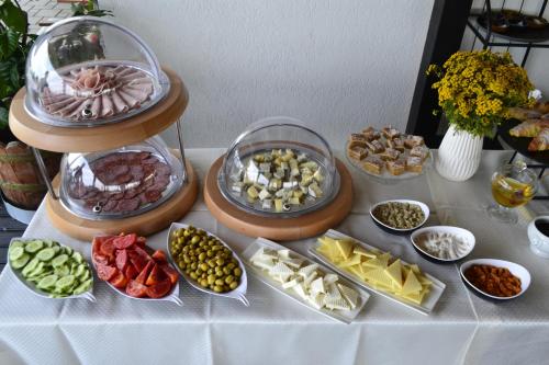 a table with different types of food on it at Forest Retreat&Spa in Oveselu