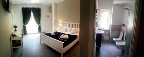 a bedroom with a bed and a sink and a toilet at Cosmo Rooms a pochi passi da Tropea in Tropea