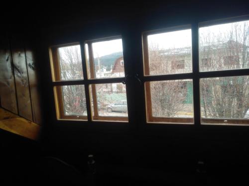 a view of three windows in a room at Universal Traveller's Hostel in San Carlos de Bariloche