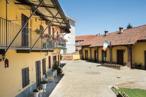 an empty alley between two buildings with a flag at Casa Del Grande Vecchio in Airasca