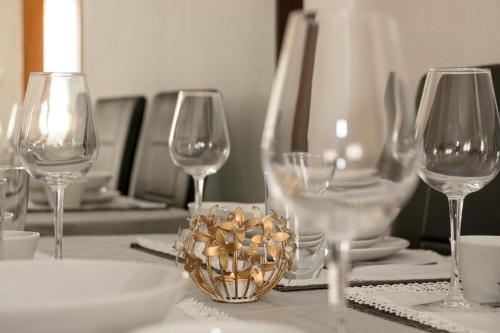 a table with wine glasses and a bowl of nuts at Residential jardín del pintor - la casa amarilla in Jacarilla