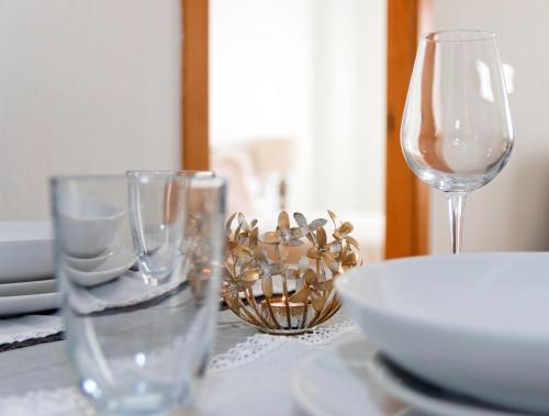 a table with two wine glasses and a bowl on it at Residential jardín del pintor - la casa amarilla in Jacarilla