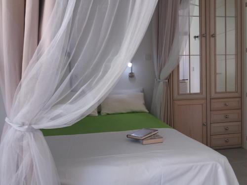 a bedroom with a bed with a curtain and a book at Aloha Paraíso in Torremolinos