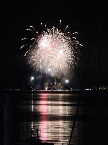 a firework display over the water at night at Hotel Capri in Lesa