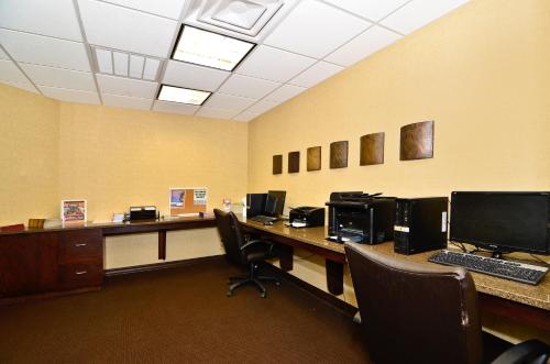 an office with two desks with computers on them at Hawthorn Suites by Wyndham Williston in Williston