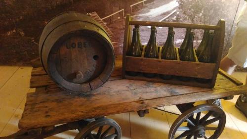 a bunch of wine bottles on a wooden cart at Kamenný dům Bezdědice-Máchův kraj in Bezdědice