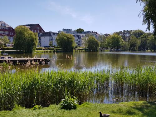 a view of a lake with buildings in the background at Seeblickstudio 2.33 im Seehof Bansin in Bansin
