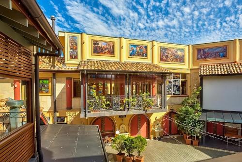 a large yellow building with lots of windows and plants at Ettalong Beach Tourist Resort in Ettalong Beach
