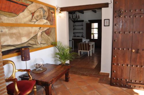 a living room with a table and a painting on the wall at Casa Silca in Marbella