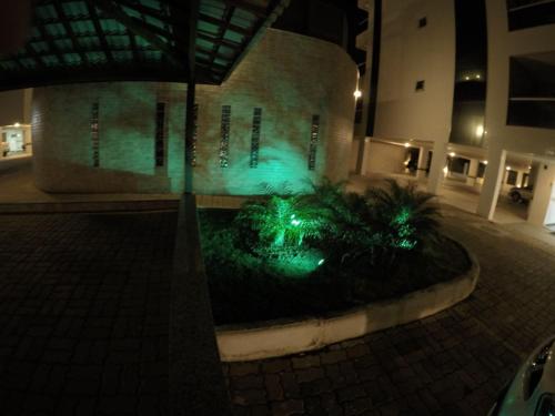 a building with green lights in front of it at Praia Grande Arraial do Cabo in Arraial do Cabo
