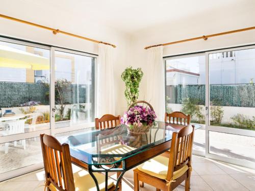 a dining room with a glass table and chairs at Holiday Home Manta Rota 450m from the Beach by Interhome in Altura