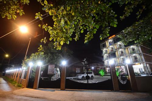 a building with street lights in front of a fence at Medea Kvariati in Kvariati