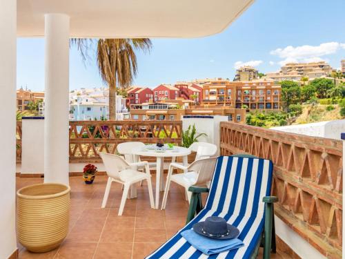 a patio with a table and chairs on a balcony at Apartment Island of Riviera Golf by Interhome in Sitio de Calahonda