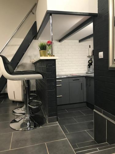 une cuisine avec un tabouret de bar dans une mezzanine dans l'établissement 52 Grand place, à Arras