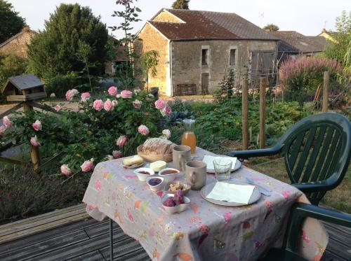 a table with a table cloth with food on it at Au rythme d Arduinna in Touligny