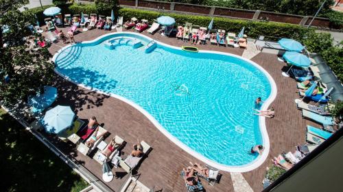 an overhead view of a swimming pool with people and umbrellas at Hotel Bisesti ***S in Garda