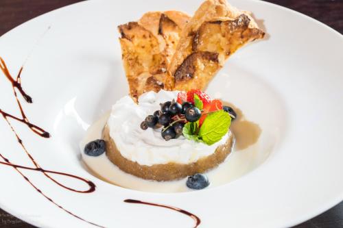 a white plate with a piece of food on it at Hotel Roberto Slanic Prahova in Slănic