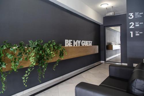 a lobby with a be my guest sign and plants at Be My Guest Athens in Athens