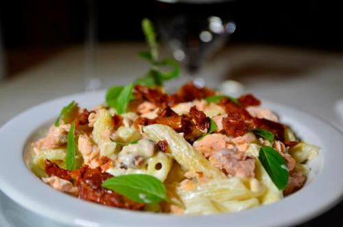 a plate of food with pasta on a table at Hotel Solaris in São Miguel dʼOeste