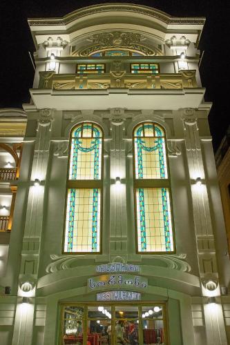 a building with stained glass windows at night at King Gorgasali in Tbilisi City