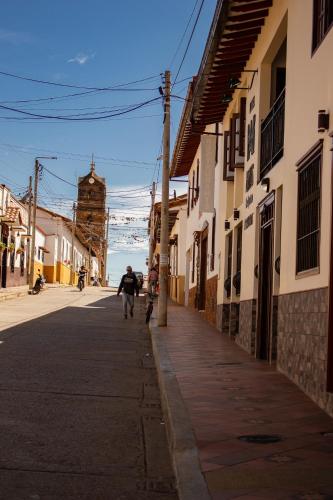 a person riding a bike down a street at Hotel Abadias De Zapatoca in Zapatoca