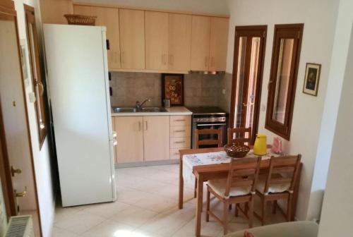 a kitchen with a table and a dining room at Villa Maria in Ierissos