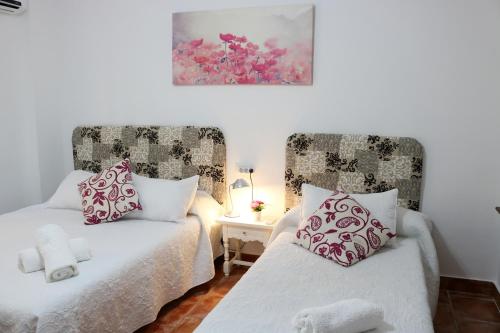 1 dormitorio con 2 camas y mesa con lámpara en Granada City Center en Granada