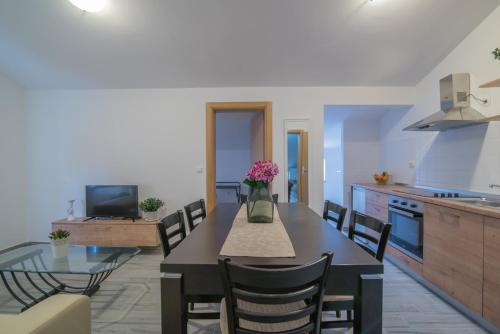 a kitchen and dining room with a table and chairs at Middle Istra in Pazin