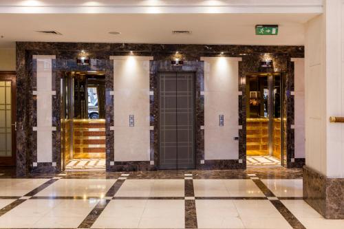 a row of elevators in a building at Plaza El Bosque Ebro in Santiago