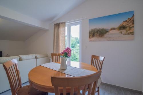 a dining room with a table and chairs and a window at Middle Istra in Pazin