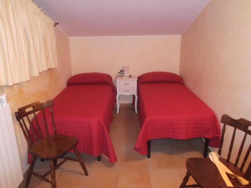 a room with two beds and a table and chairs at Agriturismo Casal Grande in Canepina