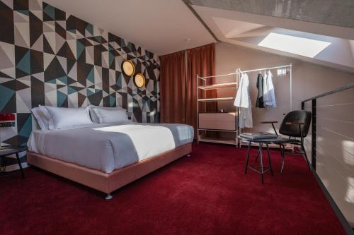 a bedroom with a bed and a red carpet at Stories Boutique Hotel in Budapest