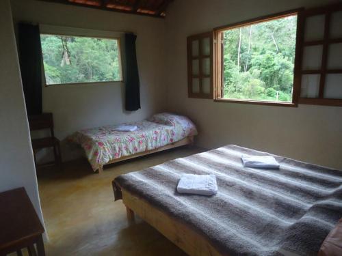 A bed or beds in a room at Hospedagem Brilho da Lua