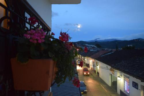 a view of a street with flowers on a building at Les Balcons Hostel in Popayan