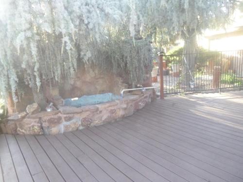 a patio with a tree and a hot tub at Sierra Inn in Prescott