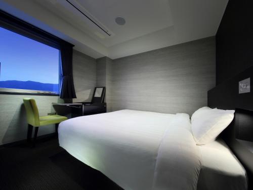 Postel nebo postele na pokoji v ubytování Venezian Hotel Shiroishi Zao
