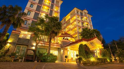 a large building with lights on it at night at Kiang Haad Beach Hua Hin in Hua Hin