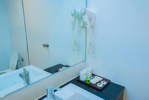 a bathroom with a sink and a mirror at Asawann Hotel in Nong Khai