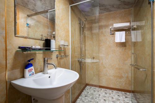 a bathroom with a sink and a shower at Venezia Cruises in Ha Long