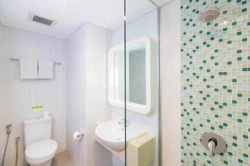 A bathroom at Zest Legian by Swiss-Belhotel International