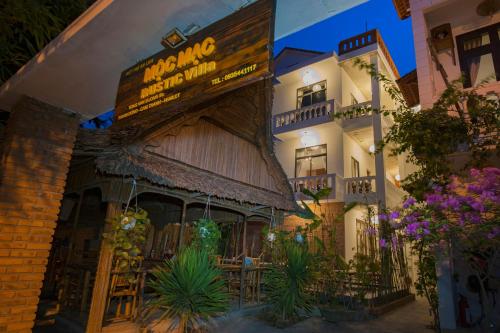 a building with a restaurant with a sign on it at Hoi An Rustic Villa in Hoi An