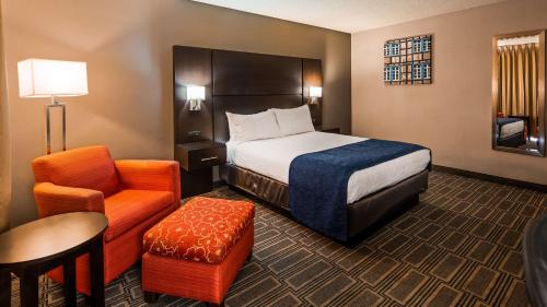 a hotel room with a bed and a chair at Best Western Andersen's Inn in Santa Nella Village
