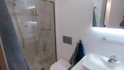 a bathroom with a shower and a toilet and a sink at OpenSky Lux in Kallithea Halkidikis