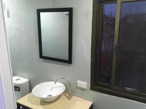a bathroom with a sink and a mirror on the wall at Mekong Riverside in Vientiane