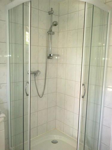 a bathroom with a shower with a glass door at Ferienzimmer Schwalbennest in Ostseebad Karlshagen
